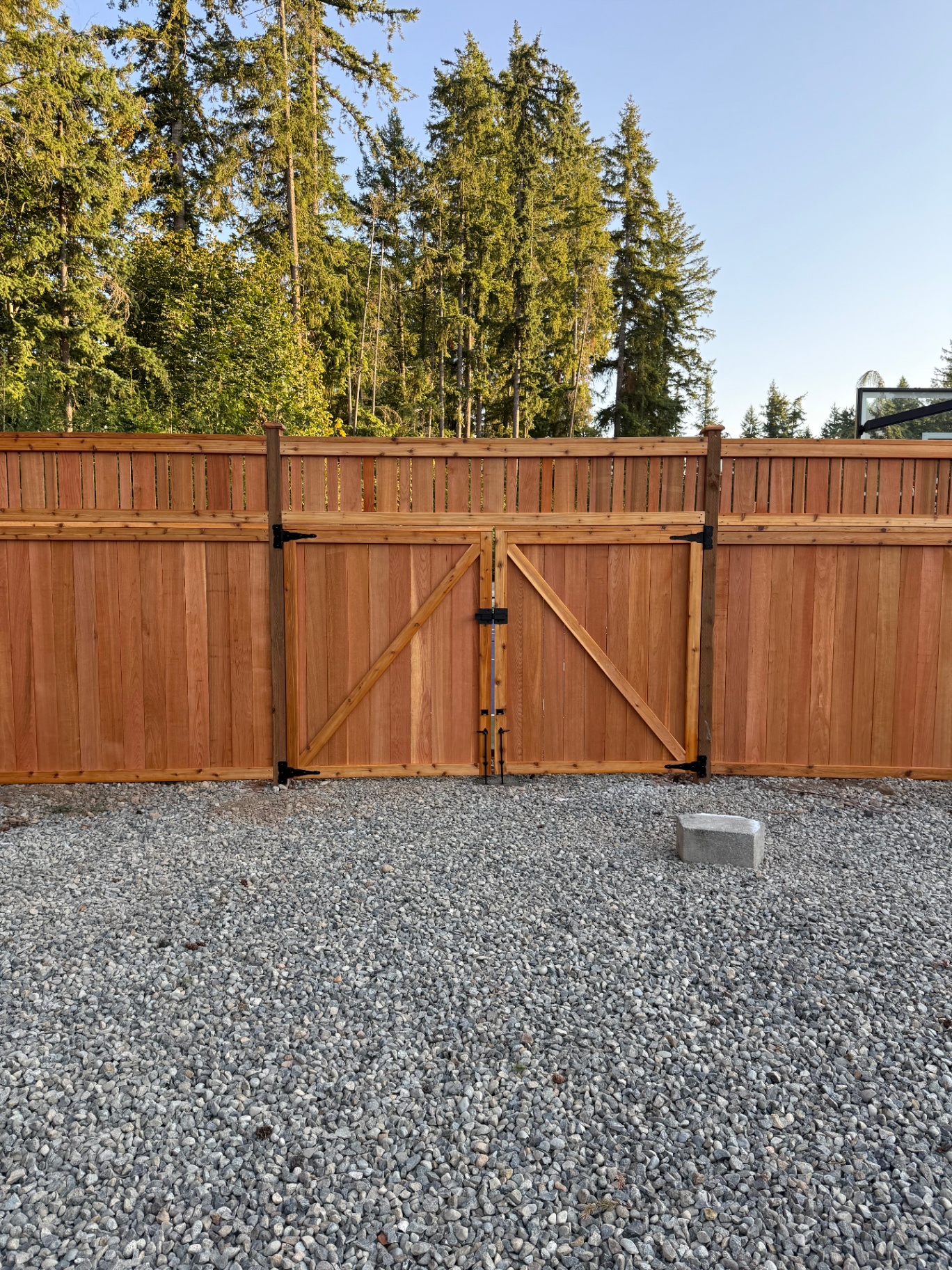 Cedar fence with vertical alternating board lattice topper and custom double gate