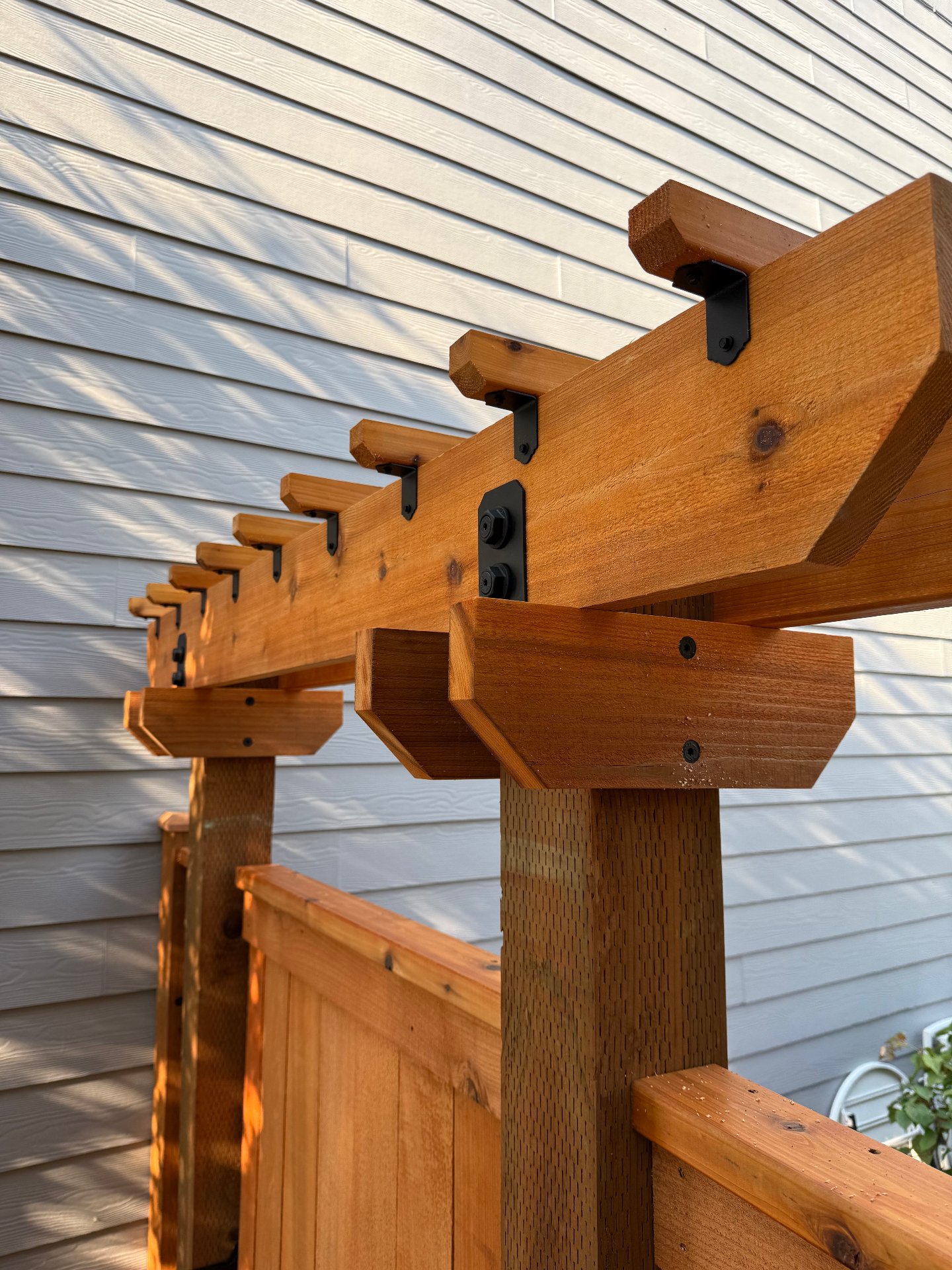 Close-up detail of chamfered trellis construction and black hardware