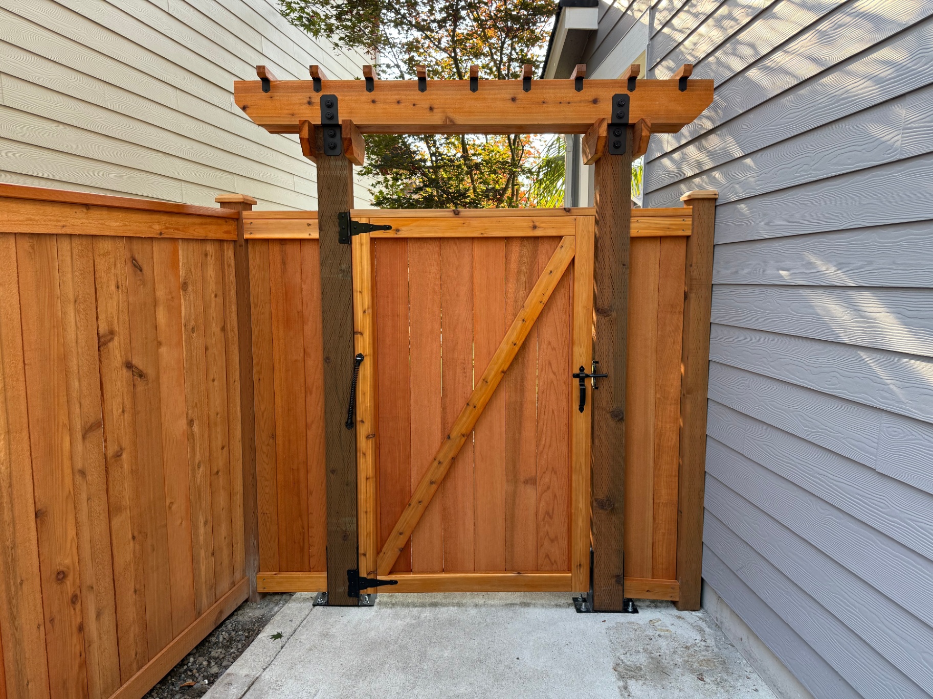 Chamfered edge trellis with black hardware over cedar gate