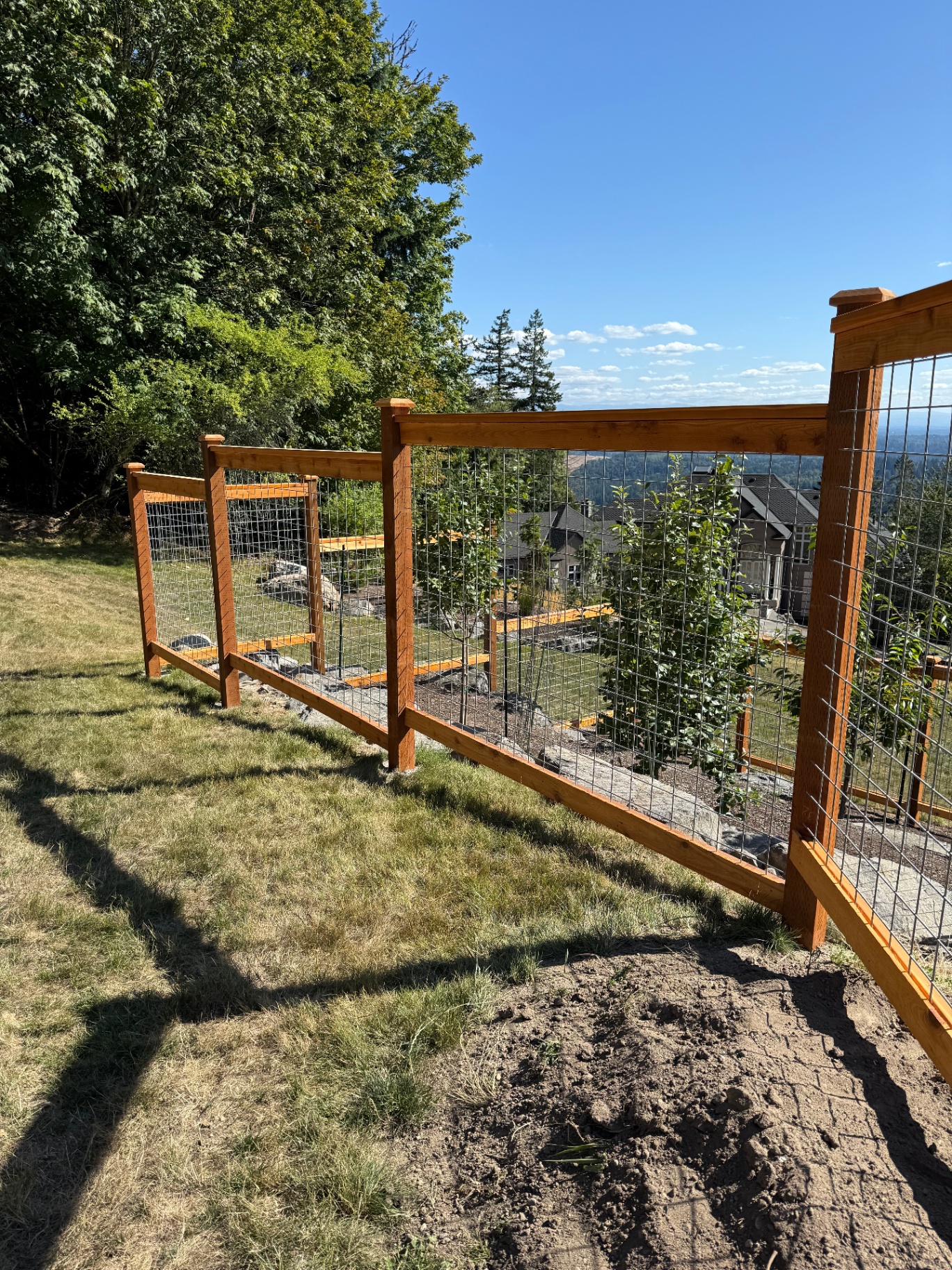 Galvanized hogwire fence on hillside terrain showing adaptability